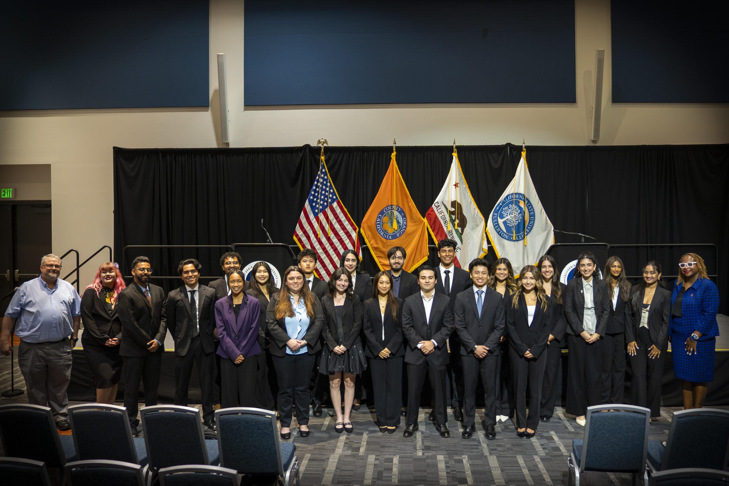 a group of young men an d women in suits