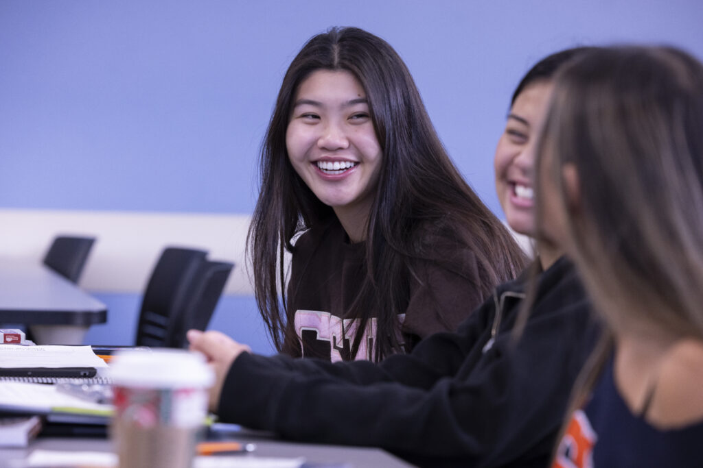 a young woman laughs with other women
