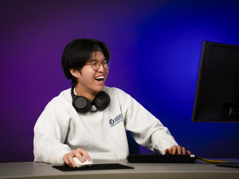 Roby Ho playing video games and smiling