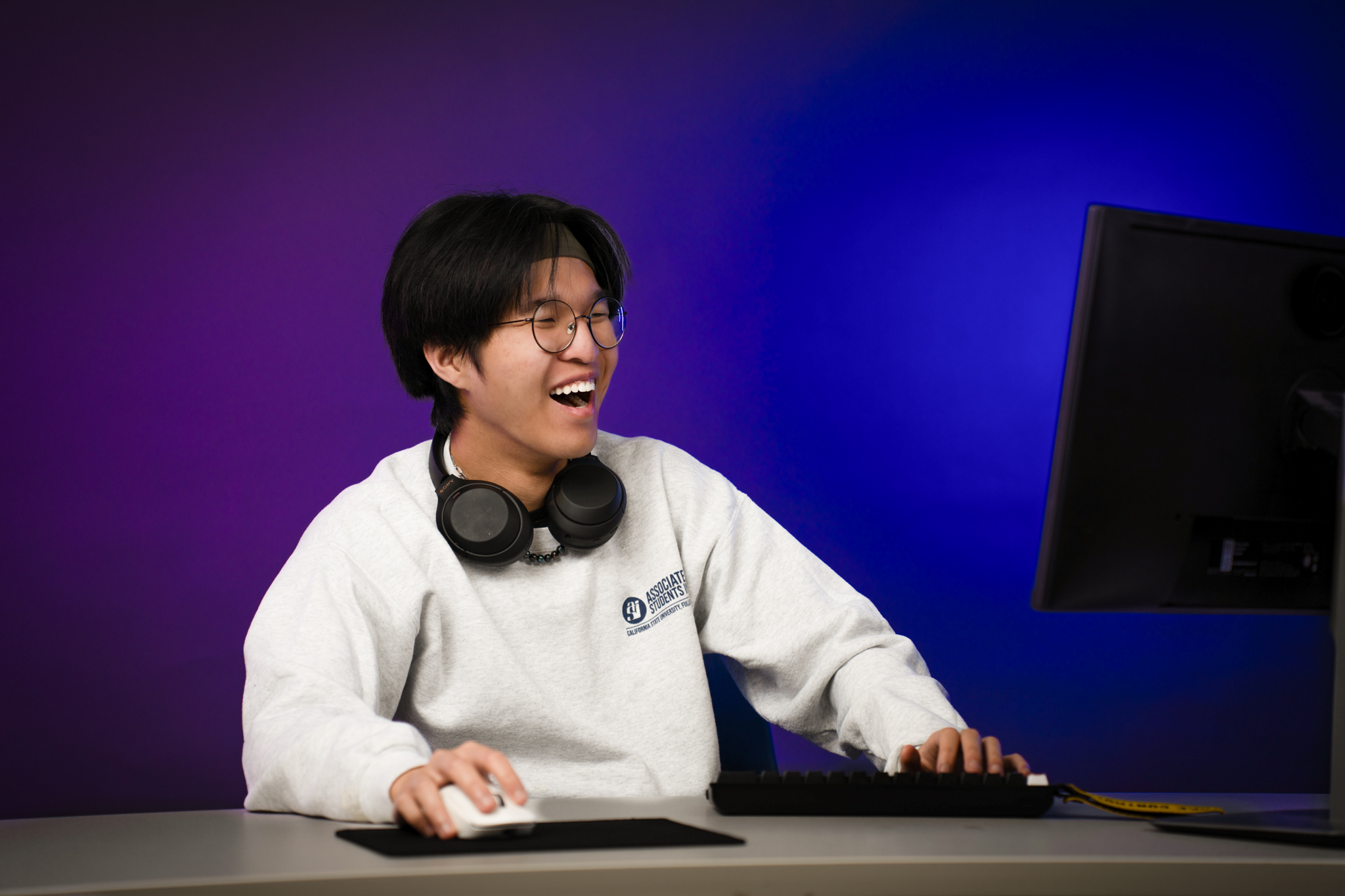 Roby Ho playing video games and smiling
