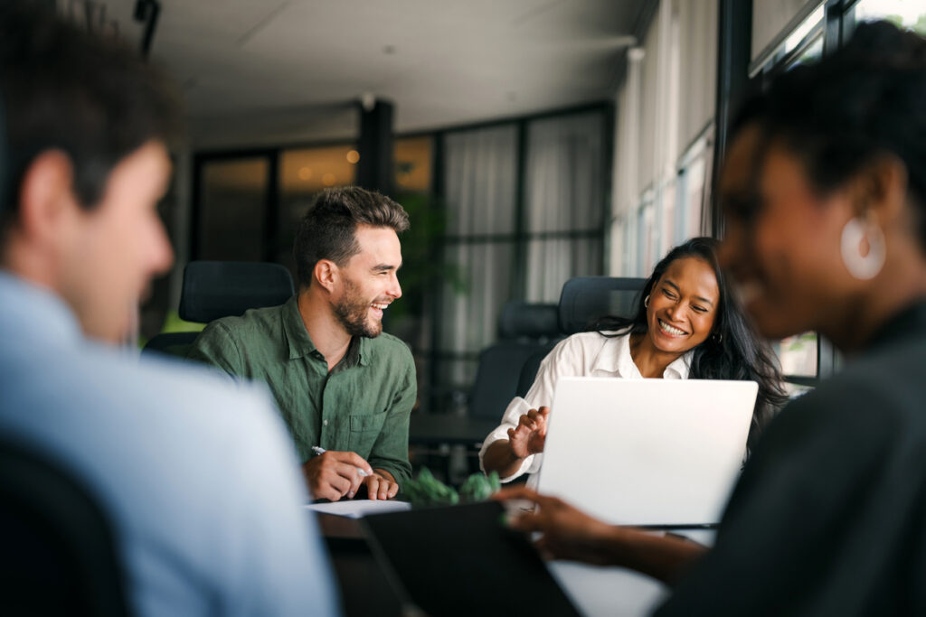 Group of young multi-ethnic startup business team collaborating on project in modern office. Young successful start-up entrepreneurs working as a team together.