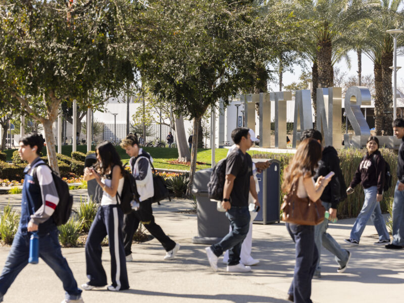 a shot of students walking on a college campus