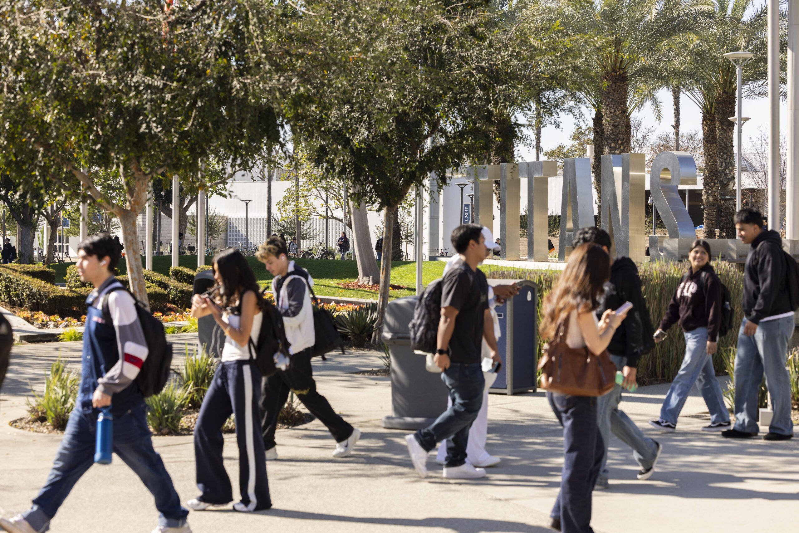 a shot of students walking on a college campus