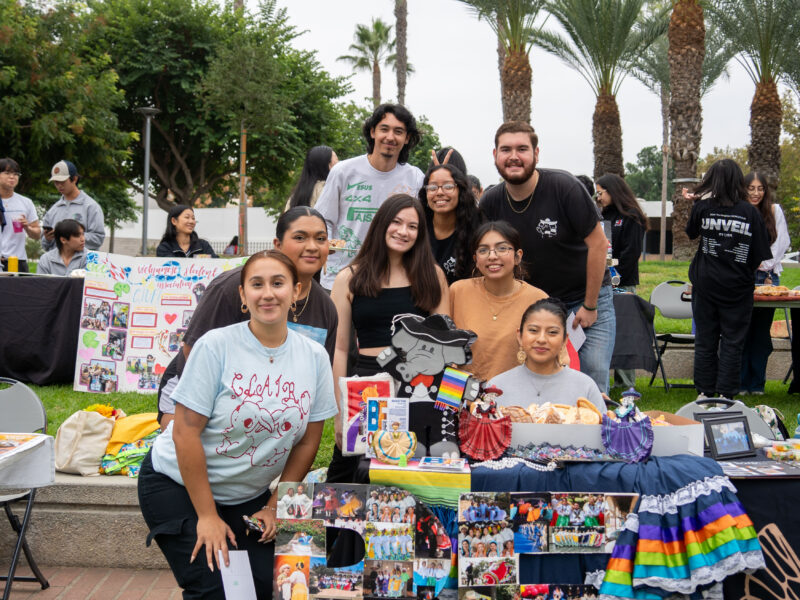 a group a smiling students at a table