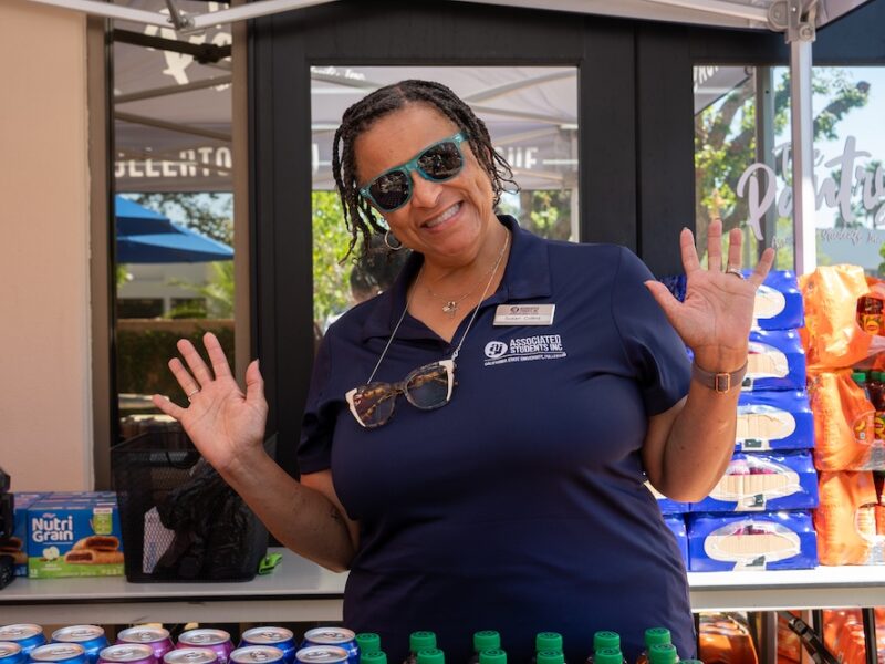 a woman smiling in sunglasses