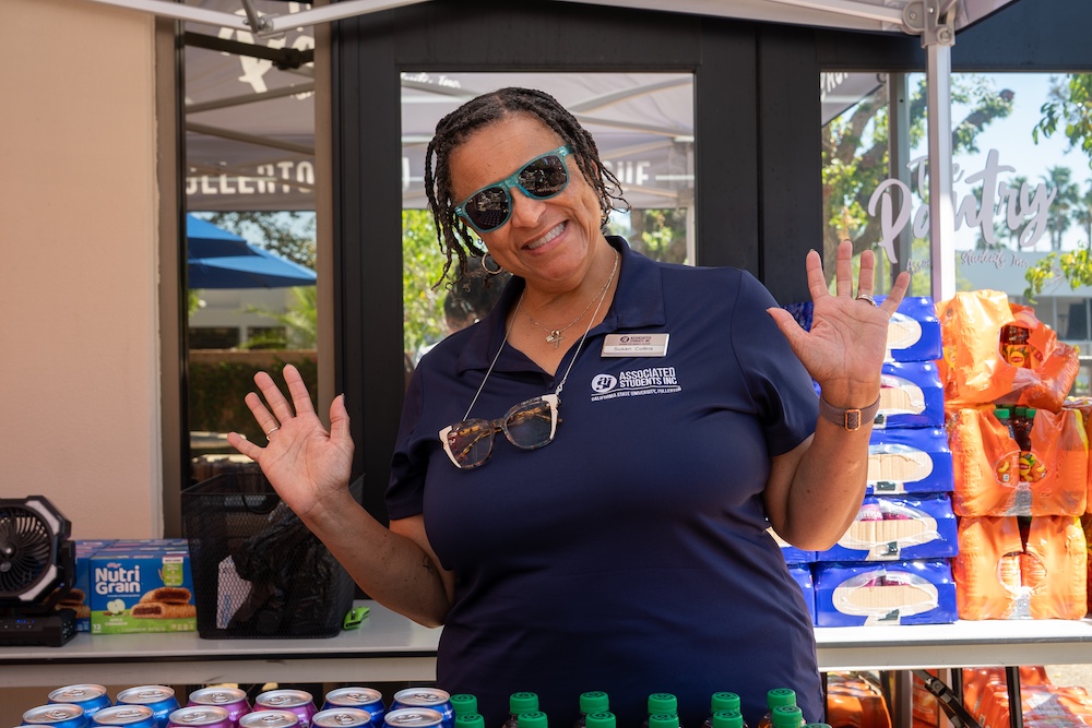 a woman smiling in sunglasses