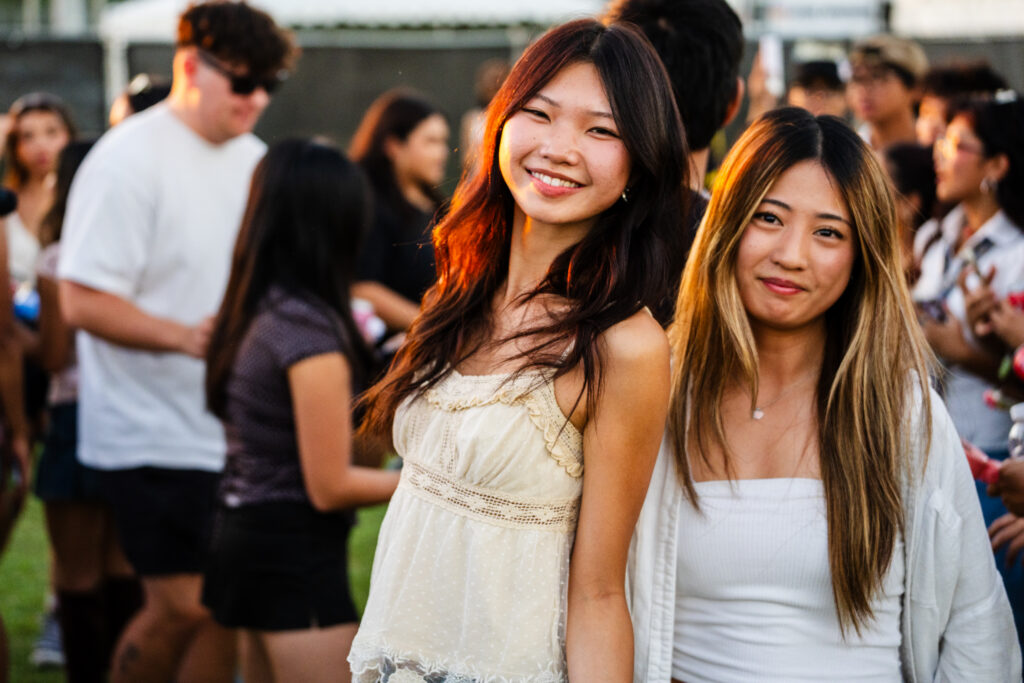 two young women smile and pose for a picture
