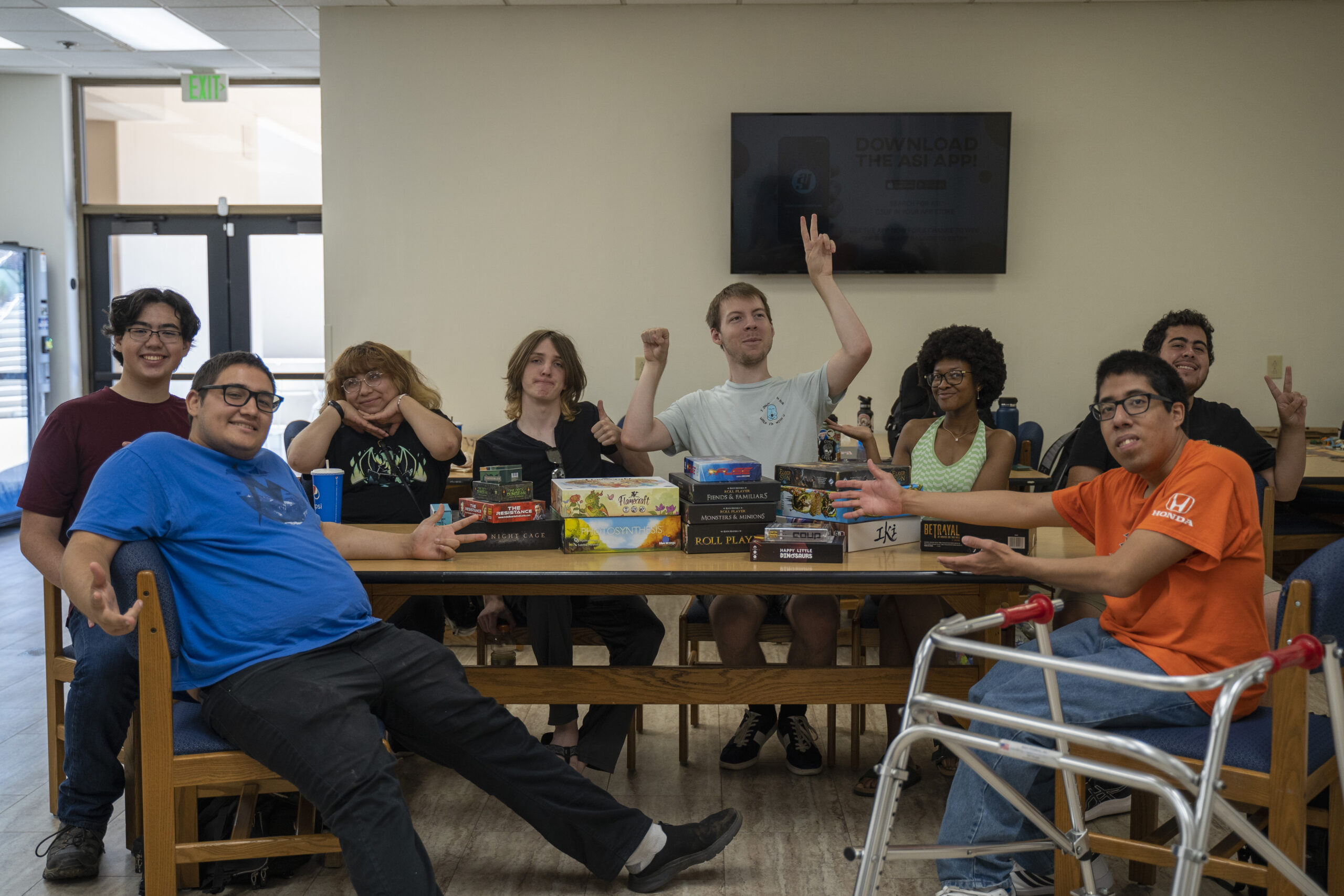 eight members of the table top games club meet in the titan student union