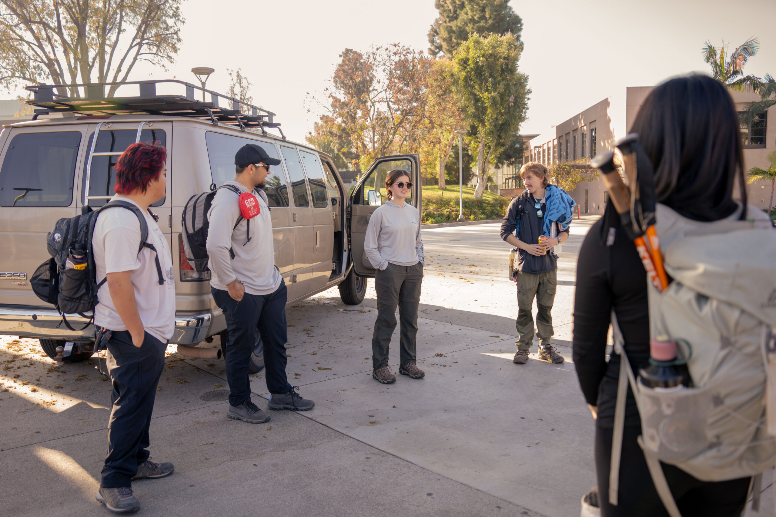 students wait near a van outside the TSU to go on a hiking trip